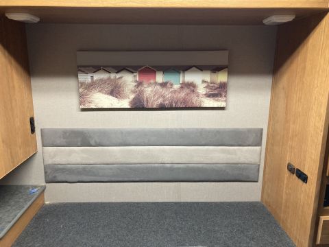 2015 Ford F-550 - Interior scene of a recreational vehicle, a headboard and artwork.