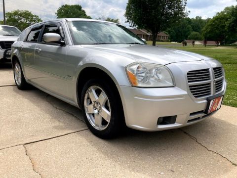 2006 Dodge Magnum - A silver Dodge Magnum station wagon is parked on a concrete driveway, with another vehicle partially visible to its left.