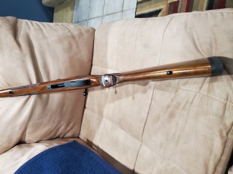 1996 Ford Bronco - A wooden hunting rifle is shown on a couch, with a blue cloth in the foreground.