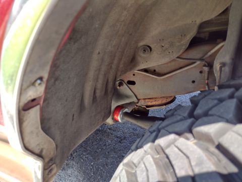 1994 Ford Bronco - This photo shows the underside of a vehicle, focusing on the suspension and wheel well area.