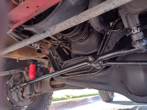 1994 Ford Bronco - This photo shows the underside of a vehicle, focusing on the suspension and steering components. The year is not discernible from the image.