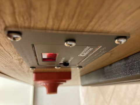 2015 Ford F-550 - Close-up of a Progressive Industries surge protector mounted to a wooden surface.