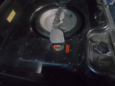 1992 Ford Bronco - Spare tire well area with fuel filler and cap visible.