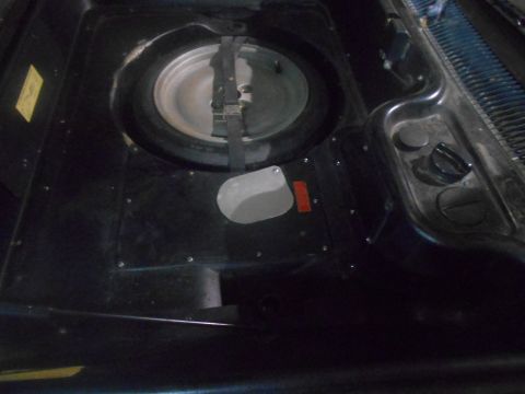 1992 Ford Bronco - The spare tire compartment is visible, showing the spare tire and its securing mechanism.
