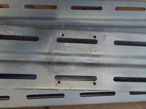 2018 Toyota 4Runner - A close-up view of a gray metal rack with multiple horizontal slots and mounting holes.