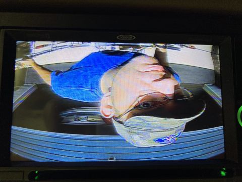 2015 Ford F-550 - A man's face is visible in a reflection on a screen, showing a blue shirt and a cap.