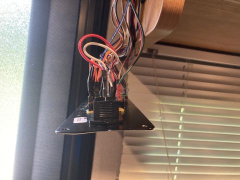 2015 Ford F-550 - An upside-down electrical panel with numerous wires is visible, attached to a surface with blinds in the background.