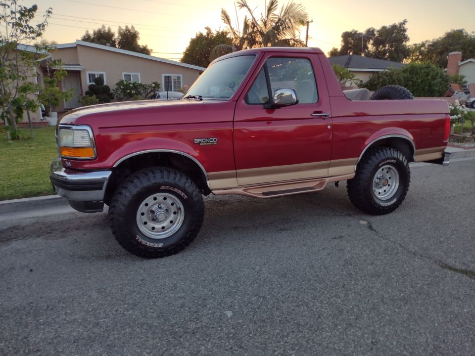 Red 1994 Ford Bronco parked on a street
