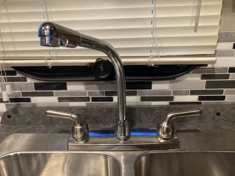 2015 Ford F-550 - A kitchen sink faucet with a pull-down sprayer is shown in front of blinds and a tiled backsplash.