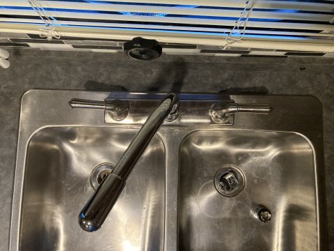 2015 Ford F-550 - A double basin stainless steel kitchen sink with a chrome faucet and handles is shown, with blinds visible above.
