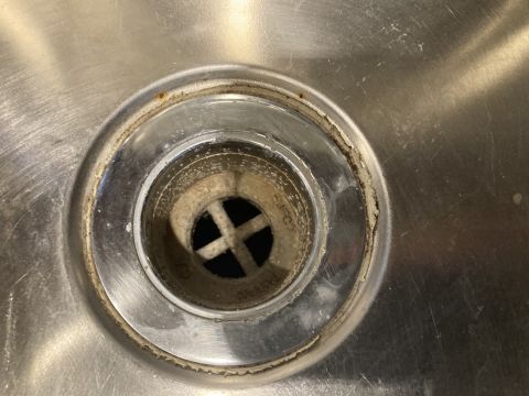 2015 Ford F-550 - The drain in this stainless steel sink shows signs of wear and buildup around the rim.