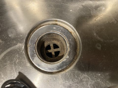 2015 Ford F-550 - Close-up of a dirty sink drain, contradicting the claim of a 2015 Ford F-550.