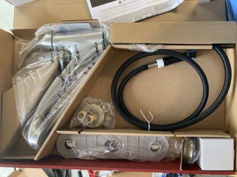 2015 Ford F-550 - New faucet and plumbing parts are neatly arranged in their original packaging, ready for installation.