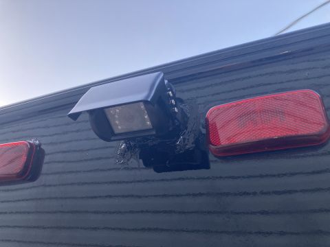 2015 Ford F-550 - Close-up of a rear view camera and tail light assembly on a vehicle's exterior.