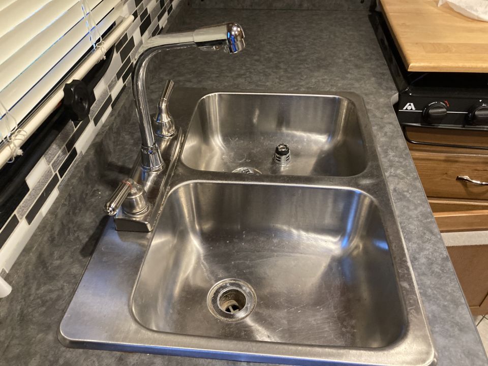Double sink with chrome faucet and backsplash