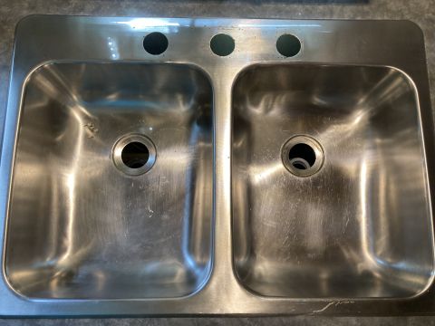 2015 Ford F-550 - This stainless steel sink features two basins and three holes for faucet installation.