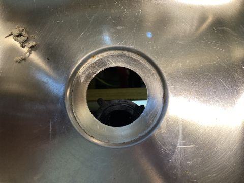 2015 Ford F-550 - Stainless steel sink drain opening with visible black plastic plumbing fitting underneath.