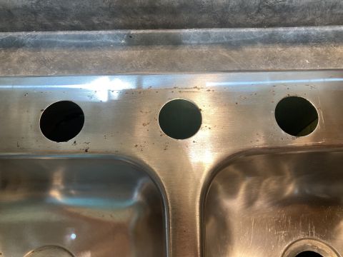2015 Ford F-550 - A close-up view of a stainless steel double sink with three holes, indicating it is not a vehicle.