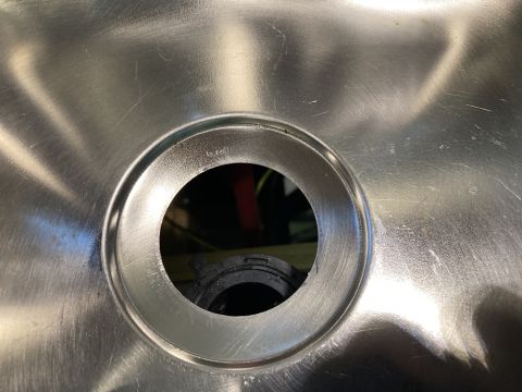 2015 Ford F-550 - Close-up of a brushed metal sink basin, showing the drain opening with a black rubber gasket visible inside.