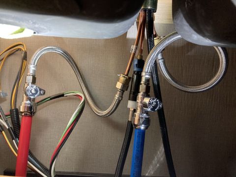 2015 Ford F-550 - Close-up view of the water supply lines and electrical wiring beneath a sink basin.