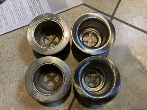 2015 Ford F-550 - Four sink strainers are shown, two with visible wear and two appearing new, on a tiled surface.