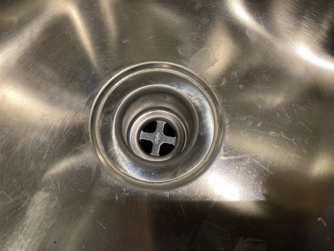 2015 Ford F-550 - Stainless steel sink drain with a cross-shaped strainer. Supermotors.net logo is visible.