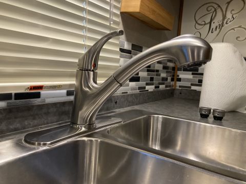 2015 Ford F-550 - A close-up view of a modern kitchen faucet and sink, with a roll of paper towels nearby.