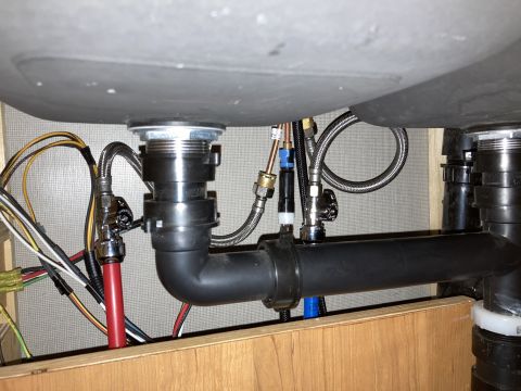 2015 Ford F-550 - Plumbing and wiring beneath a sink, showing drain pipes and water supply lines.