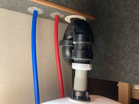 2015 Ford F-550 - Plumbing drain pipes and P-trap assembly under a sink.