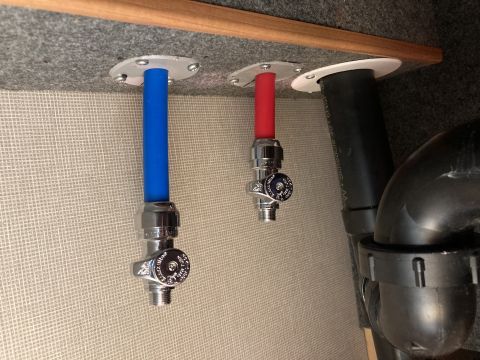 2015 Ford F-550 - Plumbing valves and pipes are visible, with blue and red tubing connected.