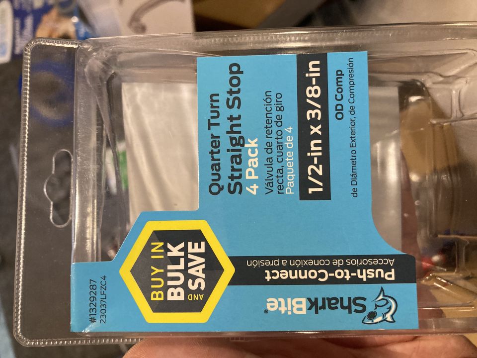 Clear plastic packaging with blue and yellow label for SharkBite quarter turn straight stop valves