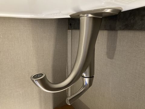 2015 Ford F-550 - A close-up view of a sink faucet, showing its brushed nickel finish and curved design.