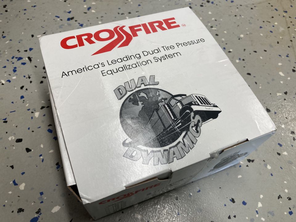 Box for Crossfire Dual Dynamics system, which equalizes tire pressure. Shows a graphic of a truck on a globe