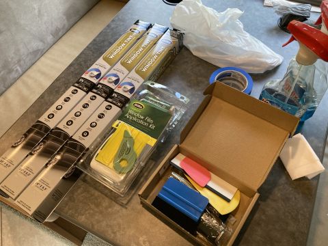 2015 Ford F-550 - Supplies for tinting car windows, including multiple rolls of tint film and an application kit with tools.