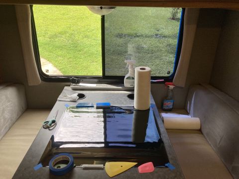 2015 Ford F-550 - Supplies for window tinting are laid out on a table inside a vehicle's cabin.
