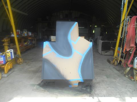 1992 Ford Bronco - Object in a garage with blue tape and gray paint, possibly being prepped for finishing.