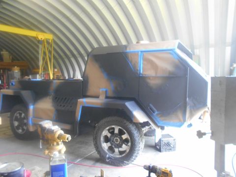 1992 Ford Bronco - Custom armored vehicle in a workshop, undergoing paint and construction.