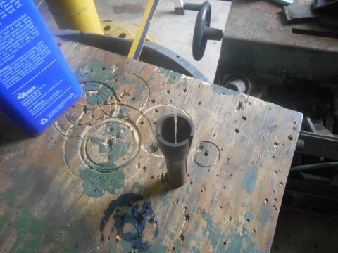 1992 Ford Bronco - A workbench surface shows wear and tear, with a tool and a bottle of cleaner.