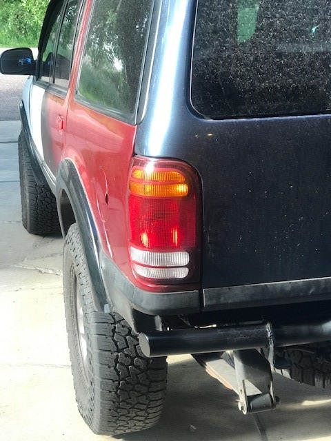 2000 Ford Explorer - This 2000 Ford Explorer shows a rear quarter view with distinct paint variations and aftermarket rear bumper.