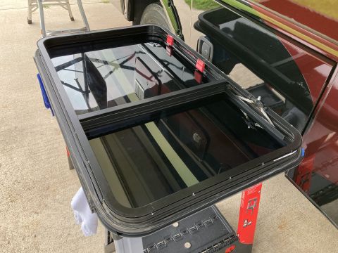 2015 Ford F-550 - A disassembled car window assembly is shown, with reflections on the glass.