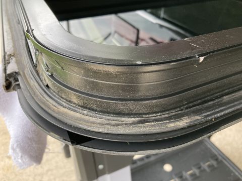 2015 Ford F-550 - A detailed view of a damaged window seal, showing wear and tear.
