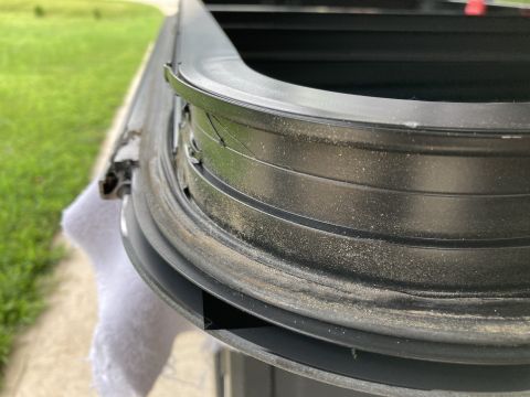 2015 Ford F-550 - Detail of a window seal and frame, showing wear and dust.