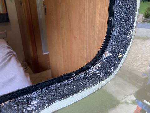 2015 Ford F-550 - Close-up of a worn window seal, revealing the adhesive and rubber components.