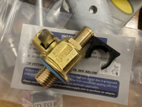 2015 Ford F-550 - A Fumoto F106 engine oil drain valve is shown with its installation instructions and a mounting clip.