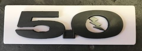 2000 Ford Explorer - This emblem reads 5.0 and features a lightning bolt design, likely indicating a performance package.