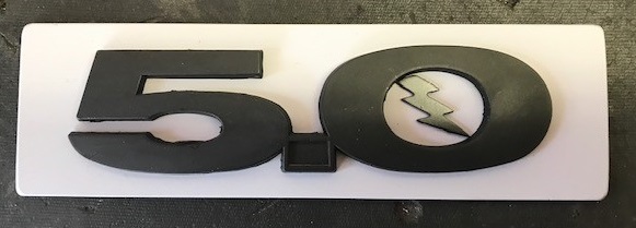 Black 5.0 emblem with silver lightning bolt on white background