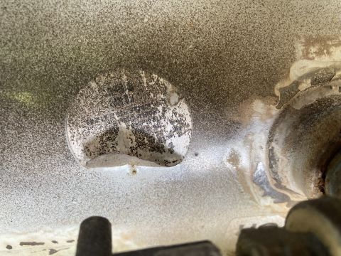 2015 Ford F-550 - Close-up of a circular metal component on the underside of a vehicle, showing signs of wear and tear.