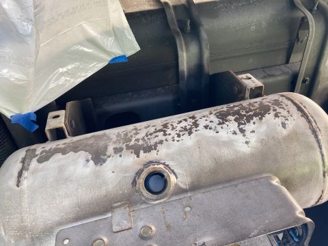 2015 Ford F-550 - Metal propane tank with visible wear and a blue cap on a fitting.