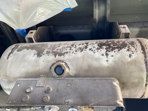 2015 Ford F-550 - This is a close-up view of a propane tank, showing its mounting bracket and weathered surface.