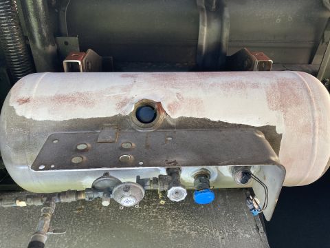 2015 Ford F-550 - Close-up of a vehicle's propane tank assembly, showing regulators and connection points.